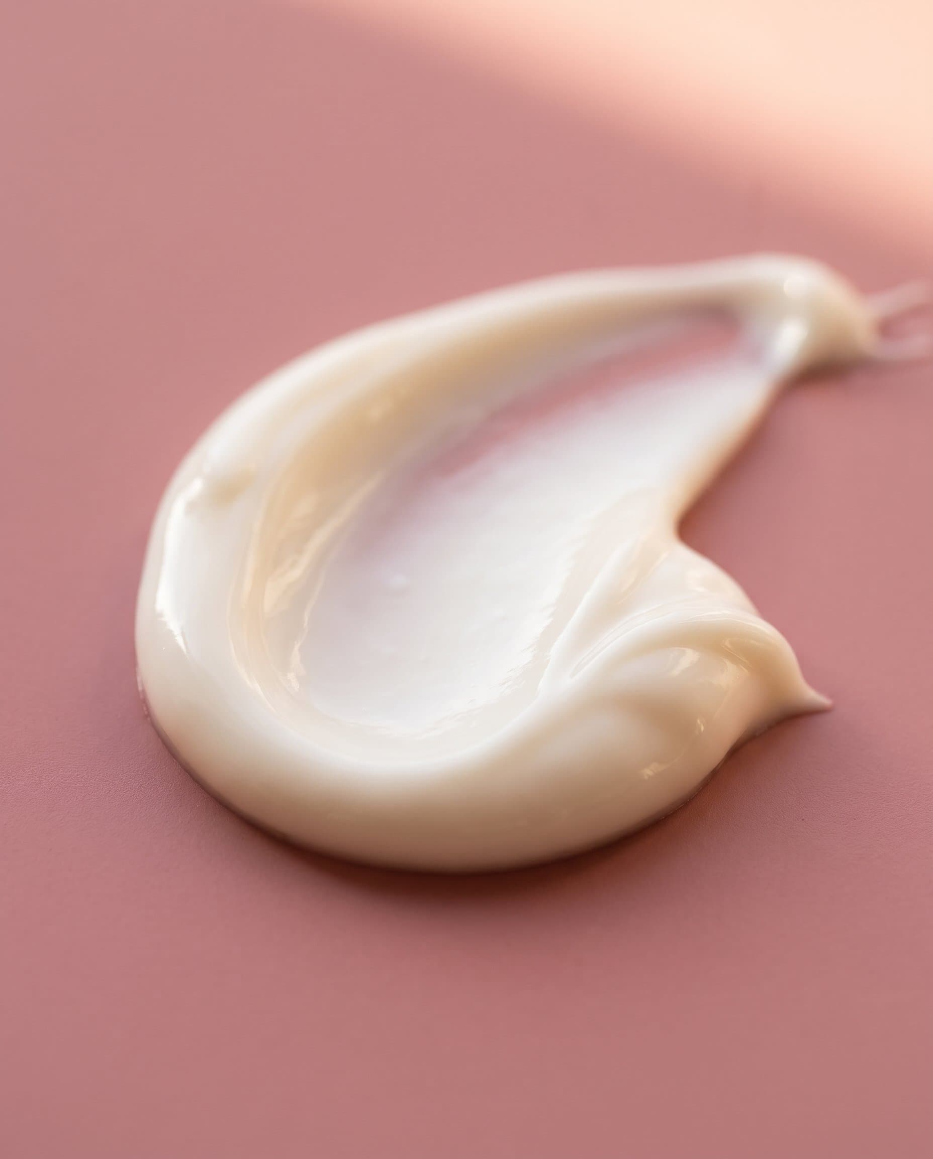 Macro of cream texture swirl on rose background
